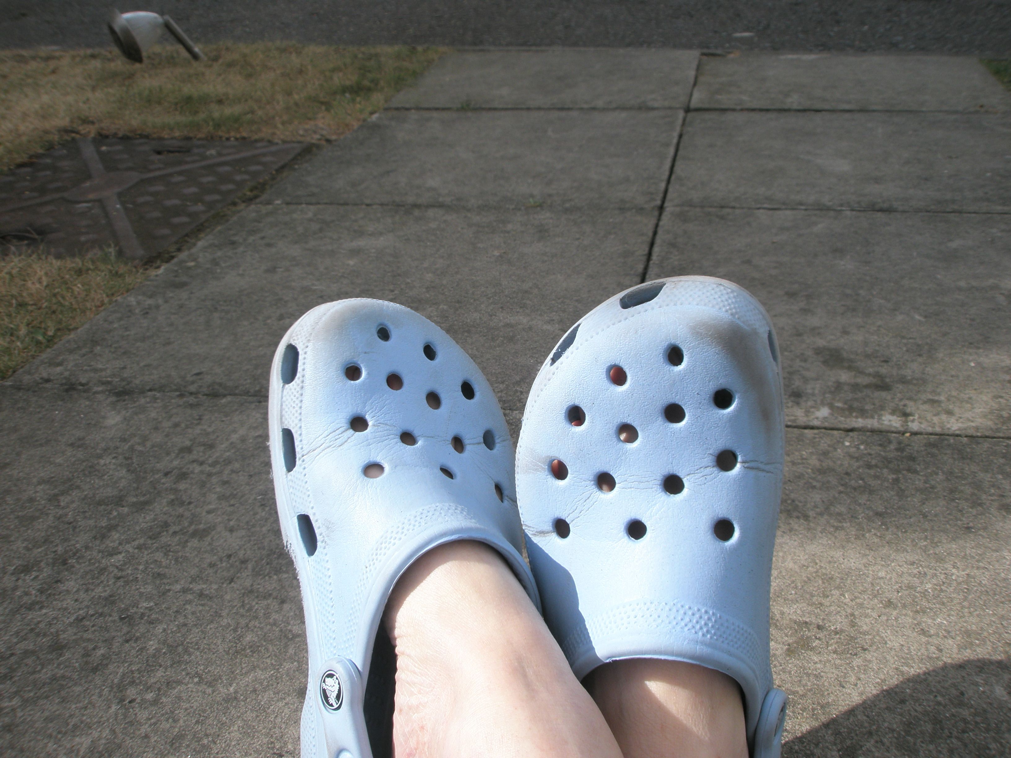 grey crocs on feet
